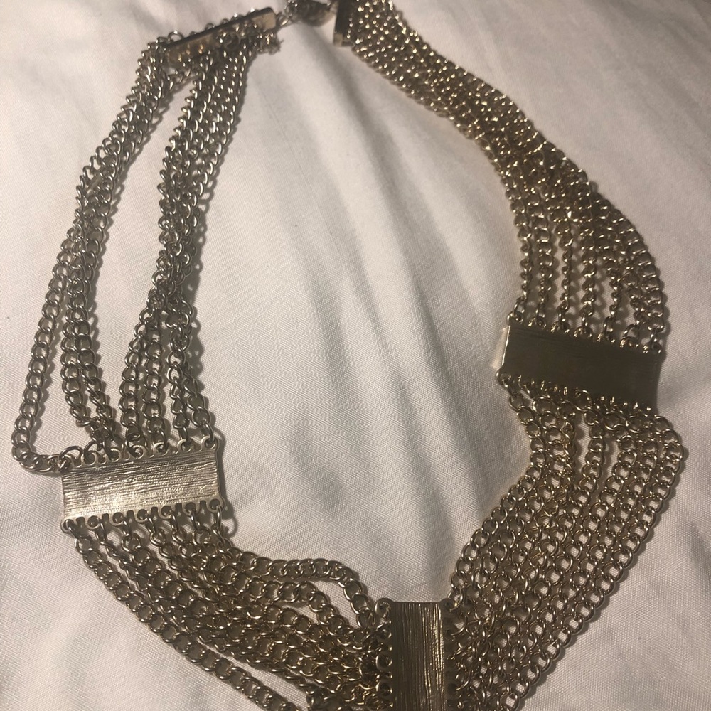 Light gold colored necklace with multiple colors
